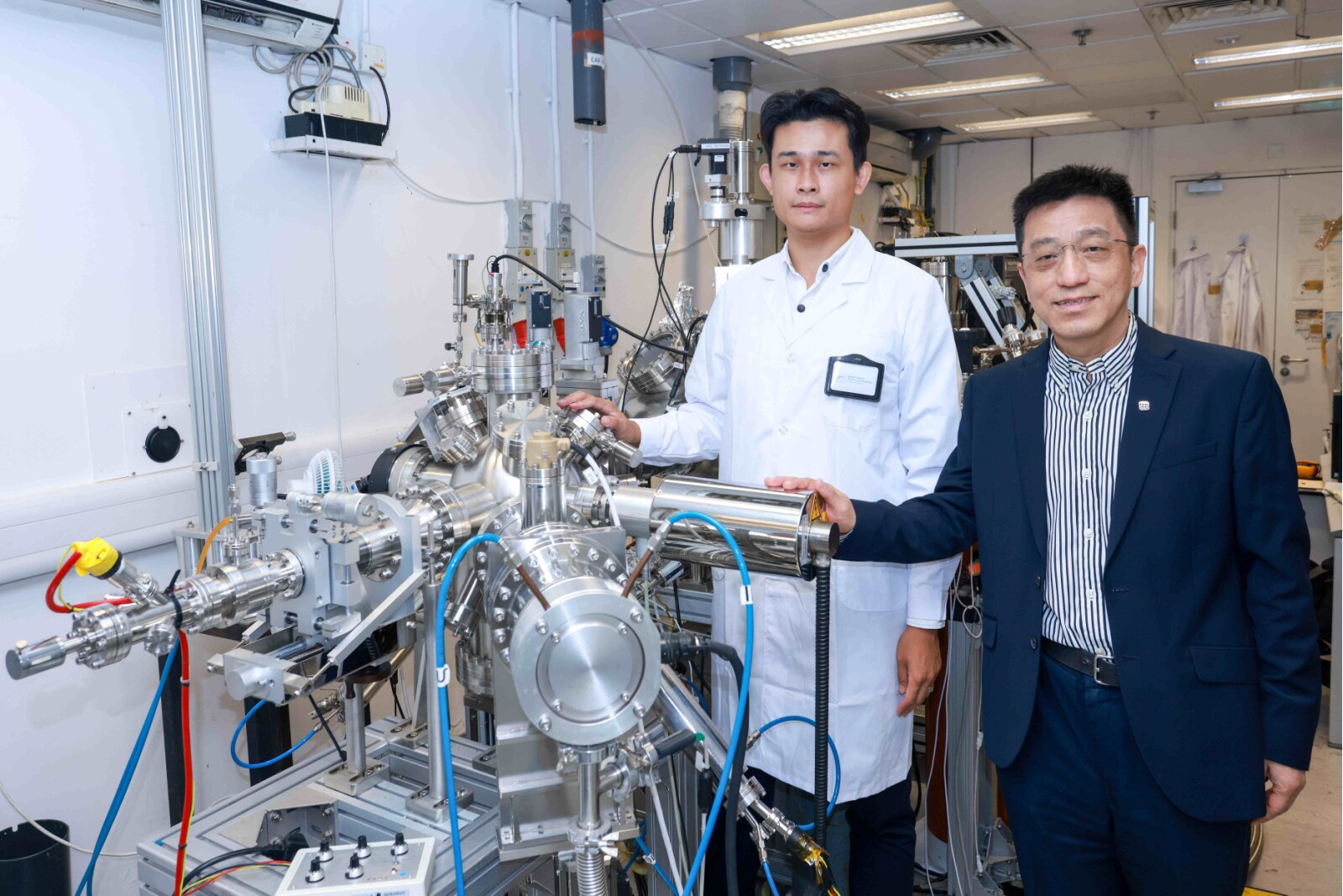 Prof. Jianhua Hao (right), Dr. Zehan Wu, Research Assistant Professor of Department of Physics and Materials at PolyU and the first author of the Research Article in Science (left), and the research team, fabricated ultra-thin heterostructure of 2D bismuth and indium selenide layers using pulsed laser deposition.